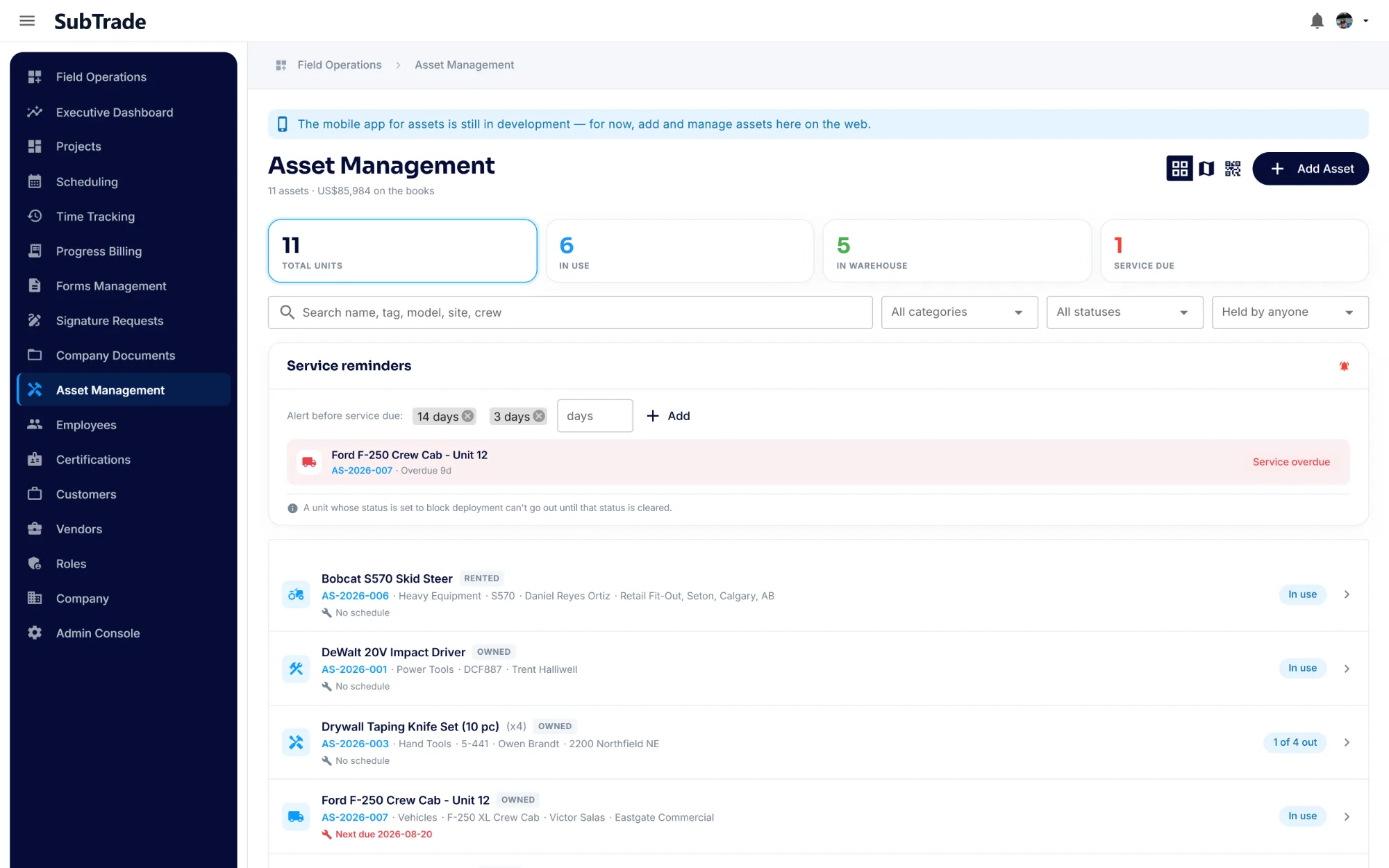 SubTrade Asset Management register listing tools, vehicles and equipment with the crew member holding each one and the job site it is on, counts for total units, in use, in warehouse and service due, and a reminder flagging a truck overdue for service
