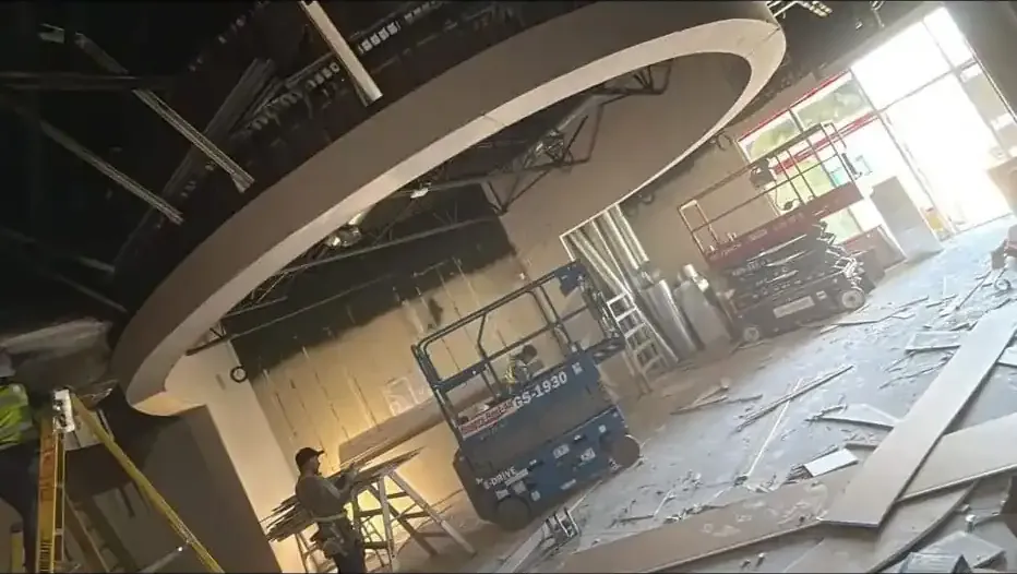 Before photo: restaurant ceiling during framing and boarding, debris on the floor